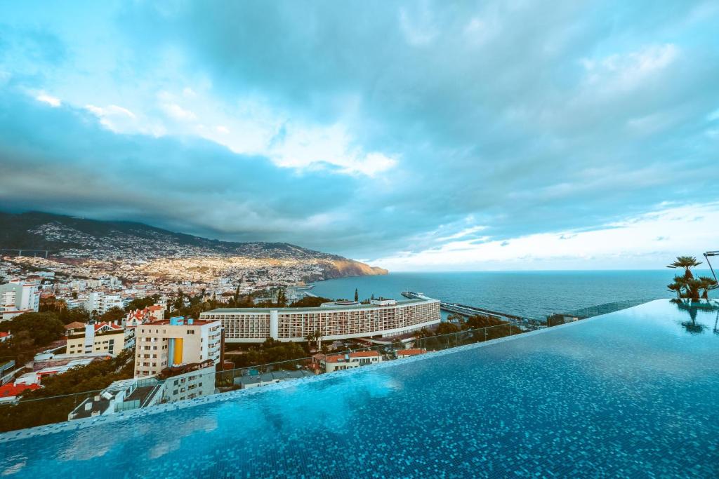 a swimming pool with a view of the ocean at Savoy Palace - The Leading Hotels of the World - Savoy Signature in Funchal