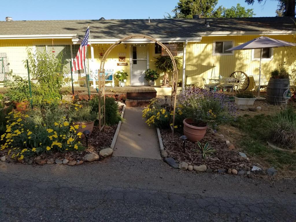 a house with an american flag and a garden at Yosemite Plaisance Bed & Breakfast in Mariposa