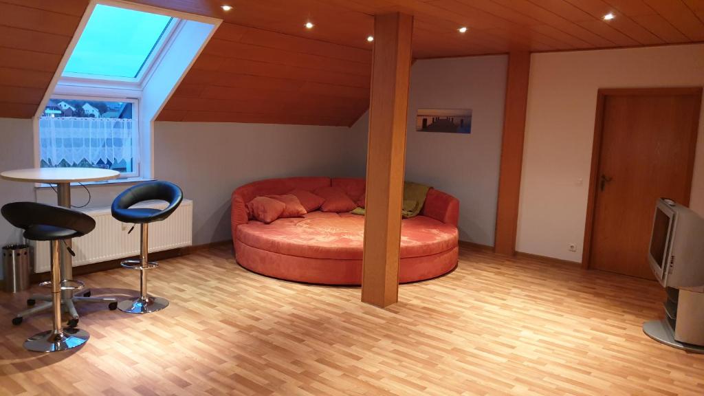 Zimmer mit einem Bett, 2 Stühlen und einem Tisch in der Unterkunft Melle Ferienwohnung in Melle