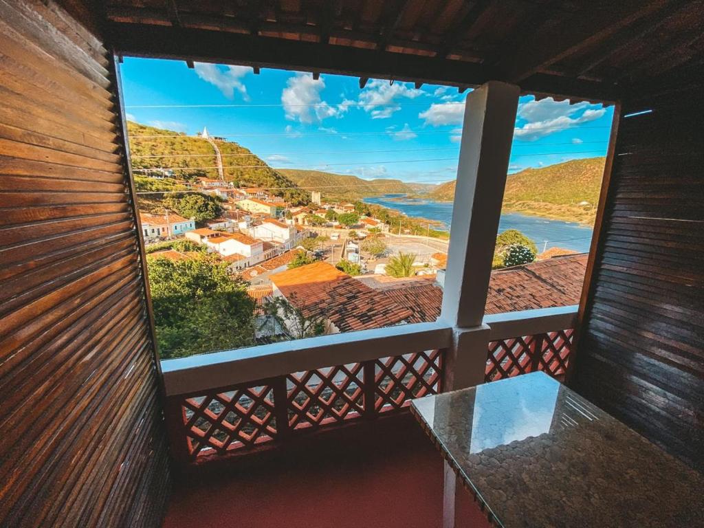 a view from the balcony of a house with a table at Pousada Asa Branca in Piranhas