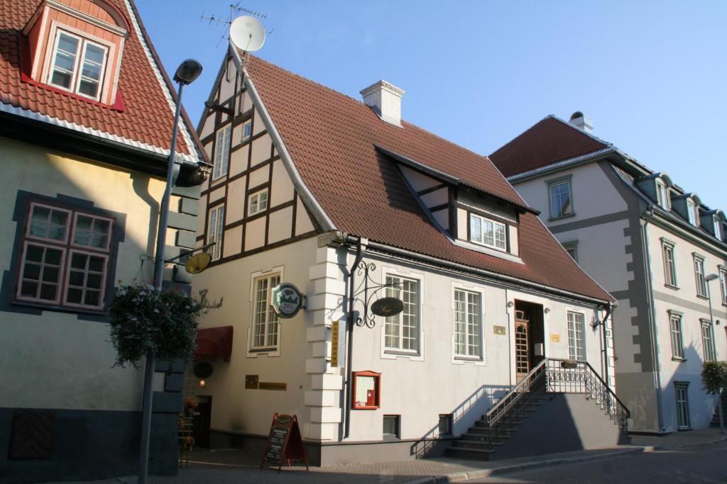 a white building with a brown roof at Alex Maja in Pärnu