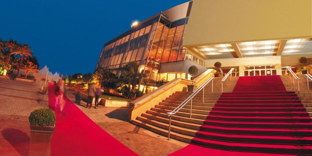 a building with stairs in front of a building at Hotel America in Cannes