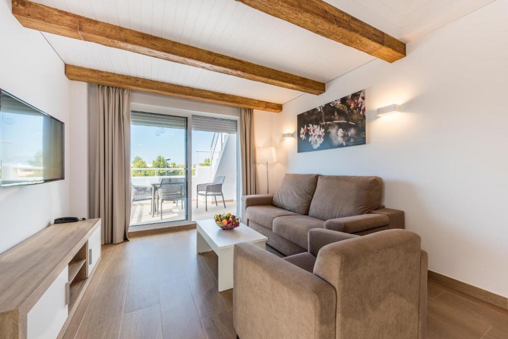 a living room with a couch and a table at Camelina Suites in San Antonio Bay