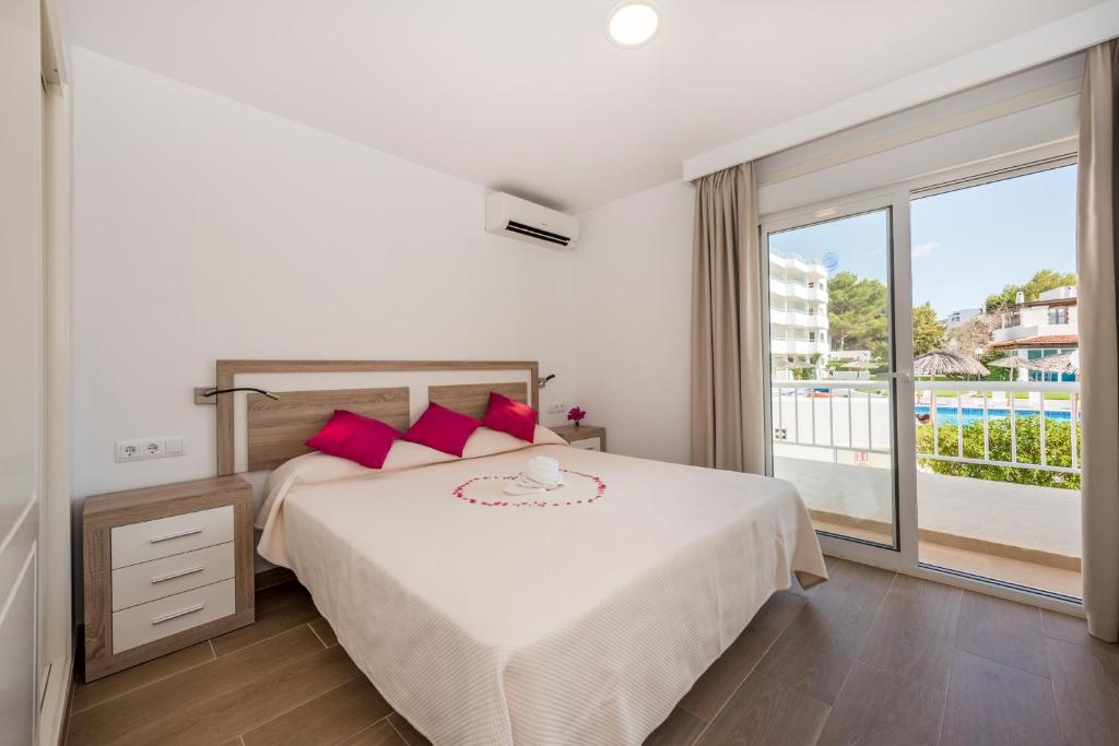 a bedroom with a bed and a large window at Camelina Suites in San Antonio Bay
