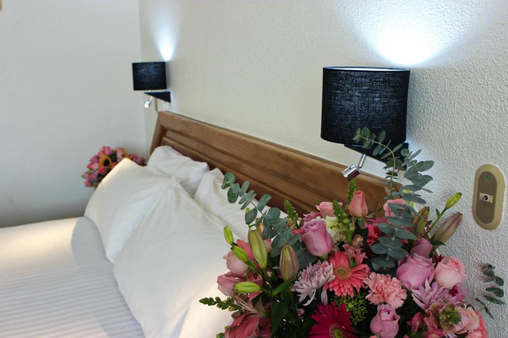 Postel nebo postele na pokoji v ubytování San Juan Park Hotel