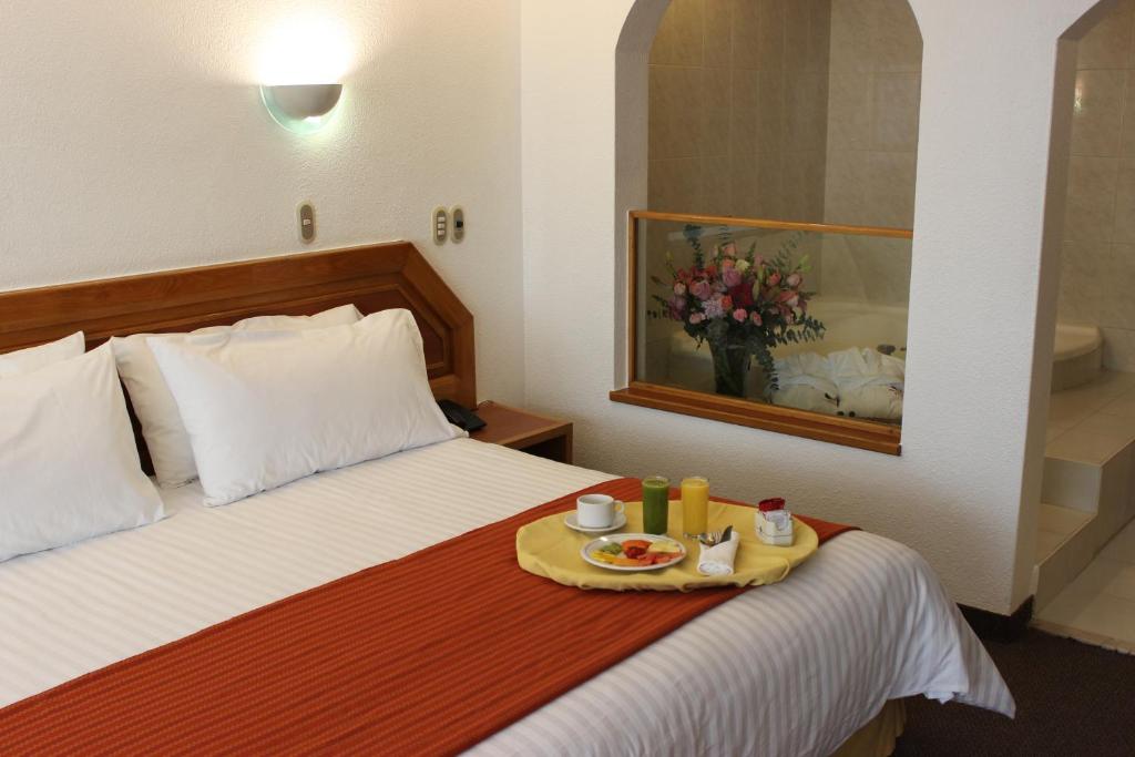 Postel nebo postele na pokoji v ubytování San Juan Park Hotel