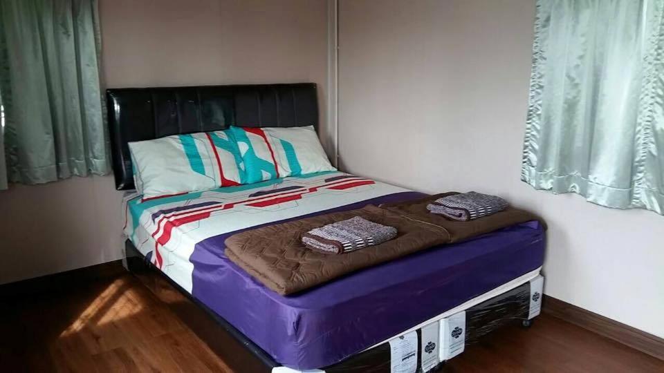 Postel nebo postele na pokoji v ubytování Nakhonyok Homestay