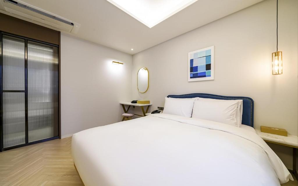 Postel nebo postele na pokoji v ubytování GijangYeonhwari No,25 Hotel