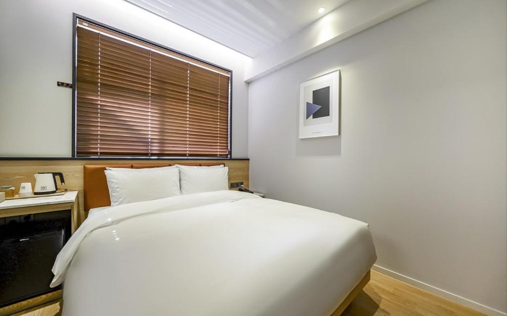 Postel nebo postele na pokoji v ubytování GijangYeonhwari No,25 Hotel
