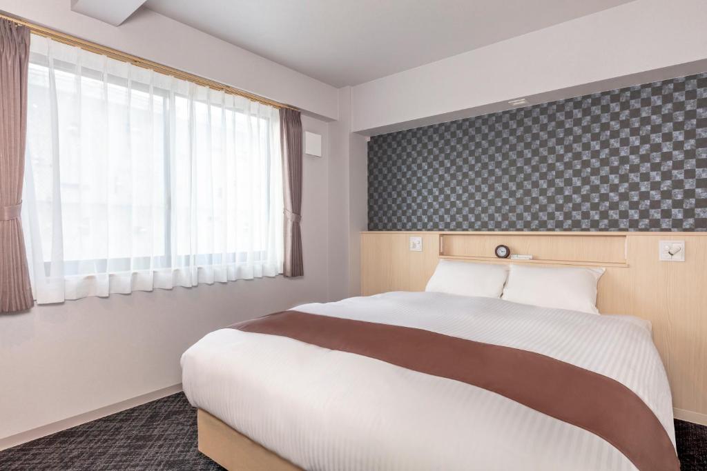 Postel nebo postele na pokoji v ubytování Hotel GOCO stay Kyoto Shijo Kawaramachi