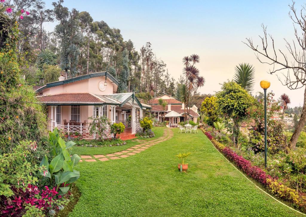a house with a garden in front of it at Club Mahindra Danish Villa, Ooty in Ooty