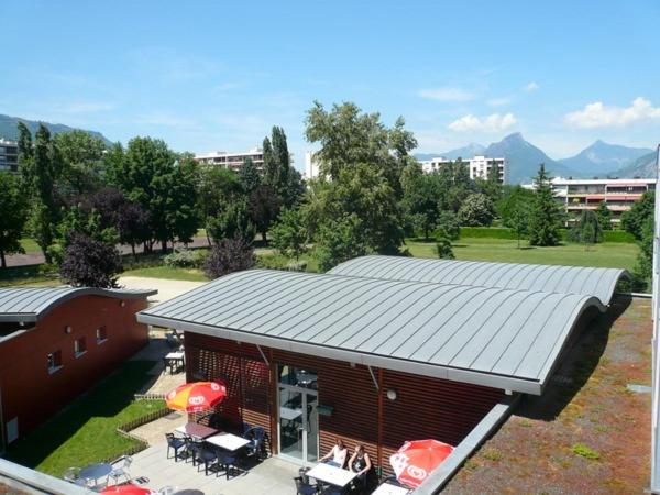 an overhead view of a building with a roof at Auberge de Jeunesse HI Grenoble in Échirolles