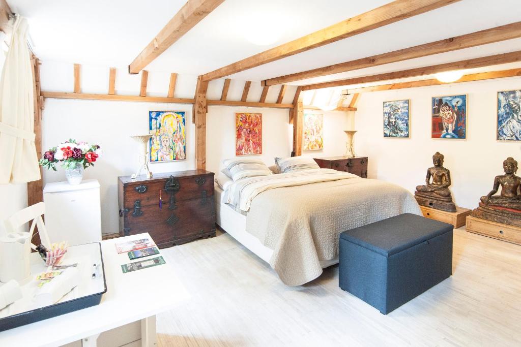 a bedroom with a large bed and a desk at Bed & Breakfast of Art in Amsterdam