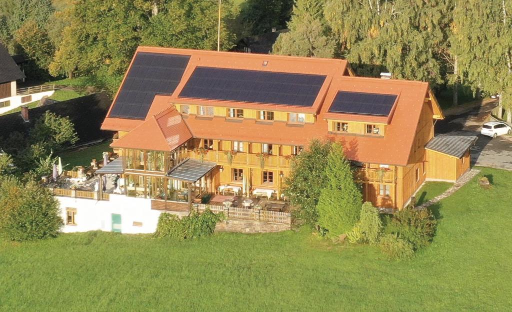 an aerial view of a house with solar panels on it at Bio - Hotel - Alpengasthof Koralpenblick in Deutschlandsberg