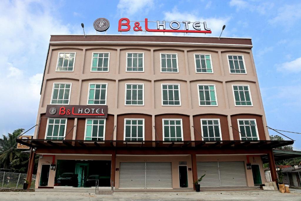 a large building with a sign on top of it at B&L HOTEl in Sungkai