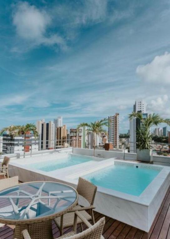 a swimming pool on the roof of a building at Manaíra Apart Hotel in João Pessoa
