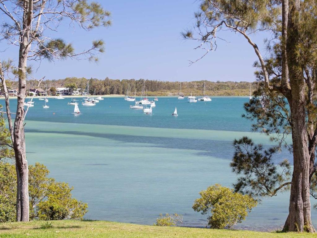 a view of a lake with boats in the water at Corlette Waterfront 2 Waterfront Luxury WI FI Aircon Boat Parking in Corlette