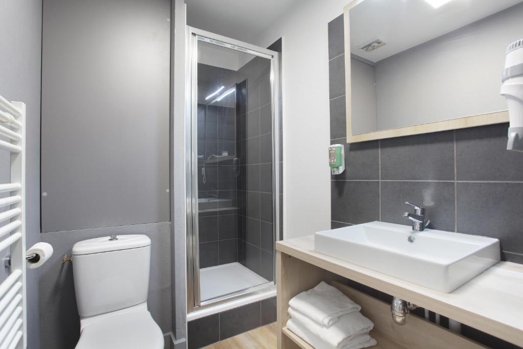 a bathroom with a sink and a toilet and a shower at Odalys City Aix en Provence Le Clos de la Chartreuse in Aix-en-Provence