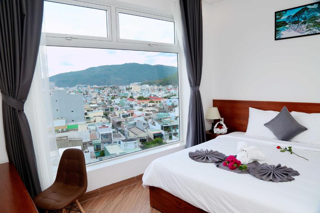 a bedroom with a bed and a large window at Thanh Van Hotel Quy Nhon in Quy Nhon