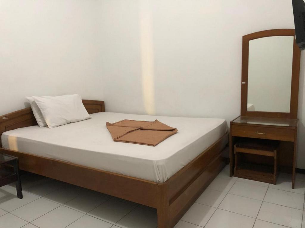 Postel nebo postele na pokoji v ubytování Hotel Baru Inn Batu RedPartner
