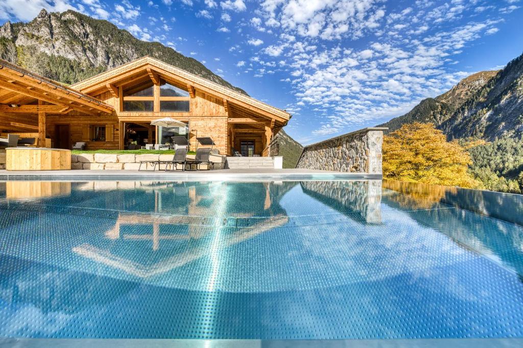 a house in the mountains with a swimming pool at Chalet GM - Gesamtes Haus by A-Appartments in Brand