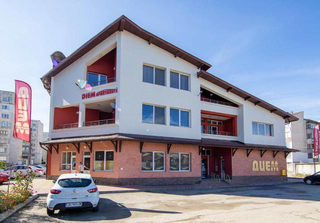 a white car parked in front of a building at Apartments DIEM in Samokov