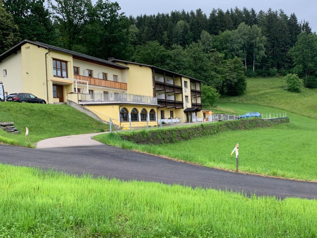 a person standing on a road in front of a building at Haus Gruber in Feldkirchen in Kärnten