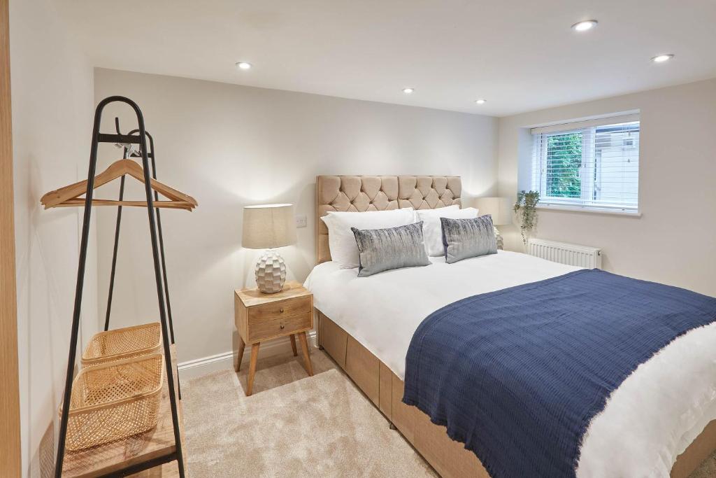 a bedroom with a large bed with a blue blanket at Host & Stay - Staffordshire Hideaway in Whitby