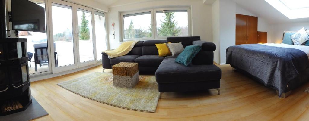 a living room with a couch and a bed at Baker's Pond Loft Apartment in Velden am Wörthersee