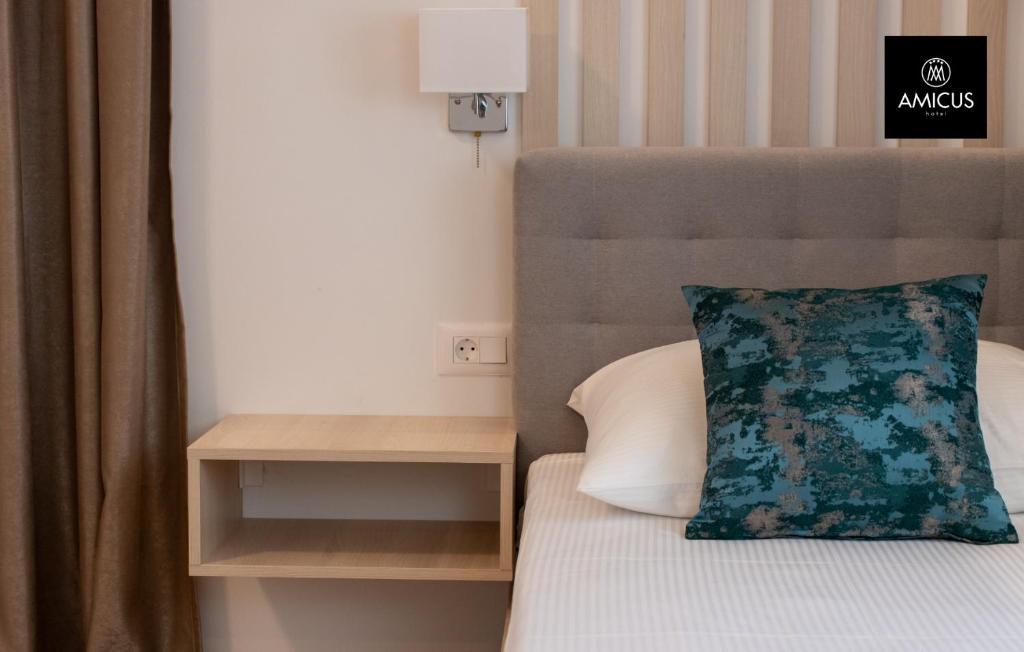 Postel nebo postele na pokoji v ubytování Hotel Amicus