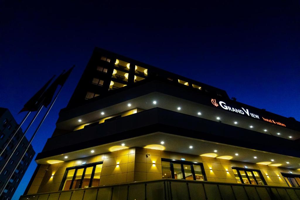 a building with lights on top of it at night at GRAND VIEW Hotel & Suites Copou in Iaşi