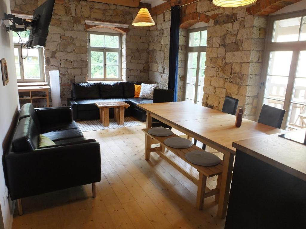 ein Wohnzimmer mit einem Tisch und einem Sofa in der Unterkunft "Meisterstube" - Hammergut Neidberg in Bielatal