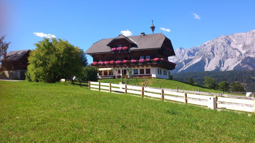 a house on a hill with a fence at Pension Patz in Schladming