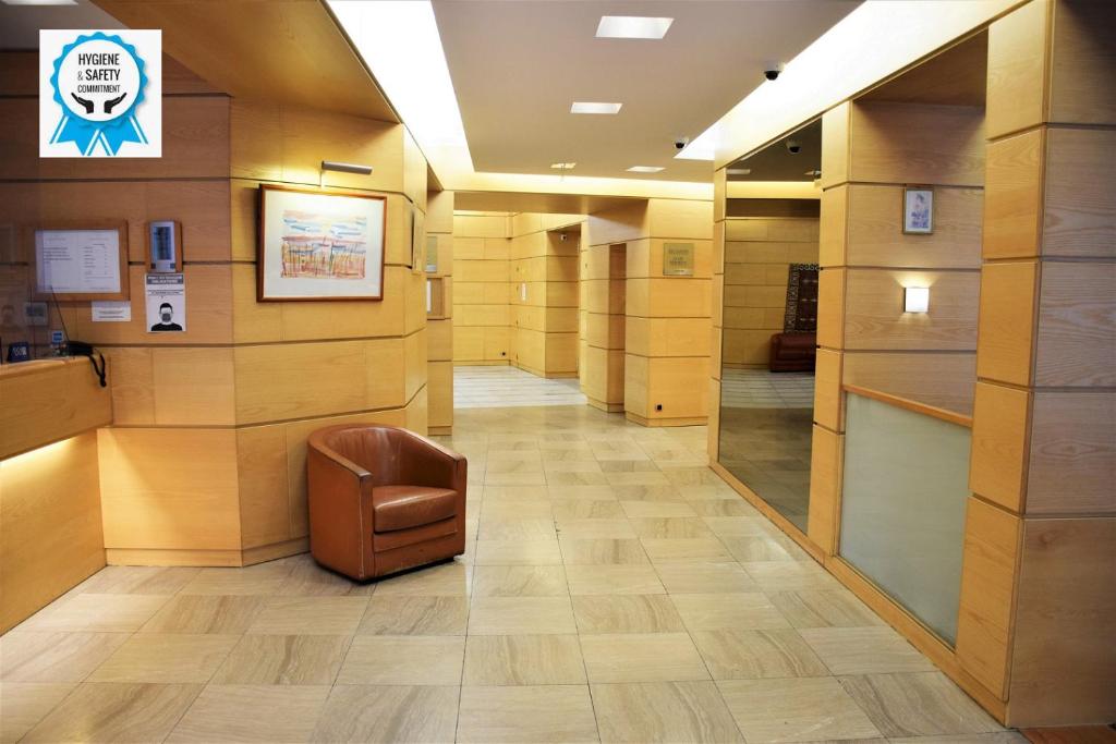 a hallway with a chair in a building at Grand Hôtel du Havre in Paris