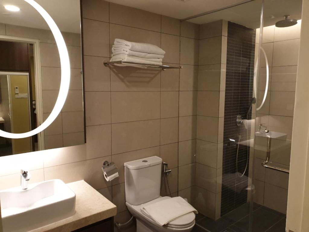 a bathroom with a toilet and a sink and a shower at Studio Suite Genting Highland 32 in Genting Highlands
