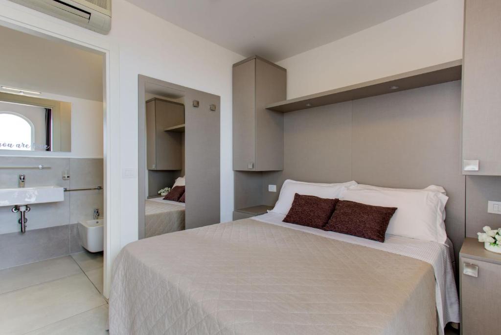 Postel nebo postele na pokoji v ubytování Hotel Villa Augustea