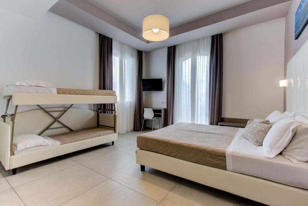 Postel nebo postele na pokoji v ubytování Hotel Villa Augustea