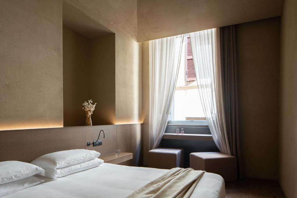 Postel nebo postele na pokoji v ubytování Hotel dei Barbieri