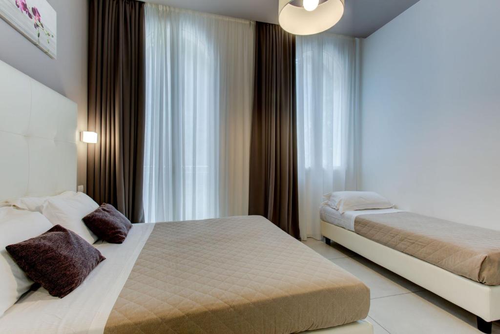 Postel nebo postele na pokoji v ubytování Hotel Villa Augustea