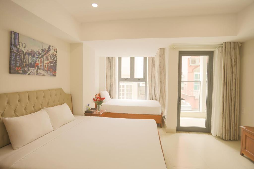 En eller flere senge i et værelse på Bao Son Hotel - Apartment