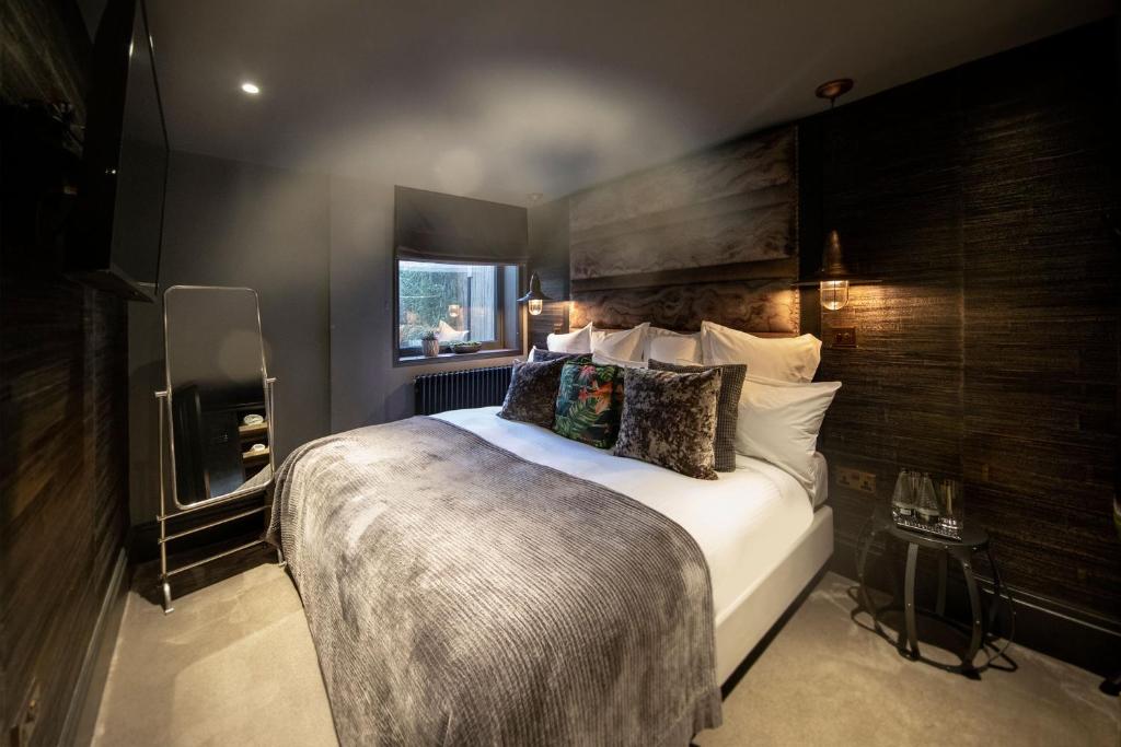 a bedroom with a large bed in a room at The Bells - Luxury Serviced Apartments in Leeds