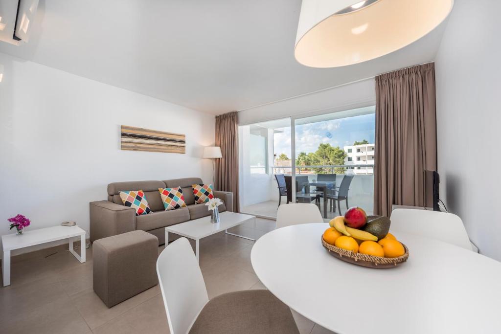 a living room and dining room with a table and chairs at Camelina Suites in San Antonio Bay