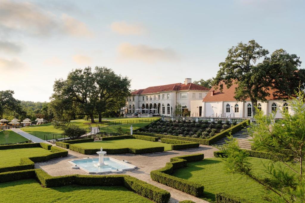 an estate with a fountain in the middle of a garden at Commodore Perry Estate, Auberge Resorts Collection in Austin