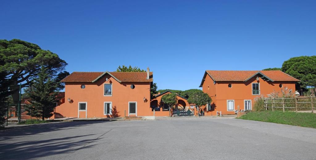 a large orange house with a road in front at Quinta da Bicuda in Cascais