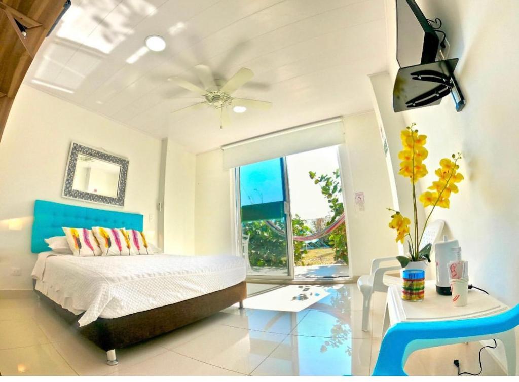 a bedroom with a bed and a large window at Sunshine Boutique Hotel in San Andrés