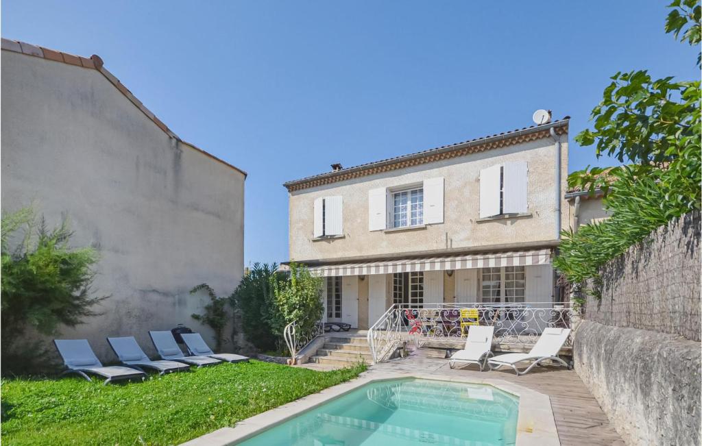 a house with a swimming pool next to a building at Amazing Home In Tulette With 4 Bedrooms, Wifi And Outdoor Swimming Pool in Tulette