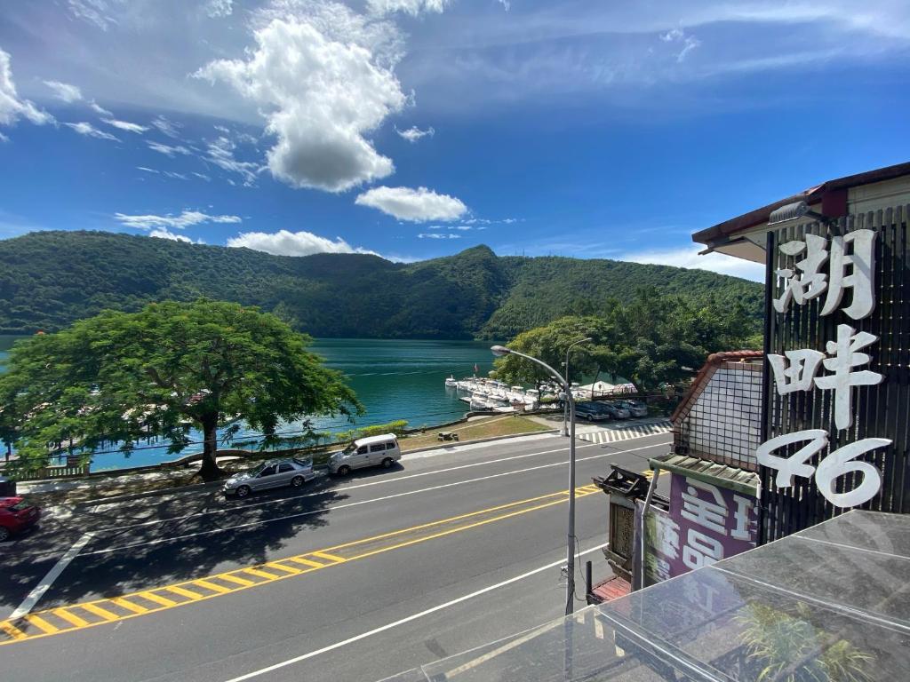 a view of a road with a river and mountains at Lakeside 46 in Chinan