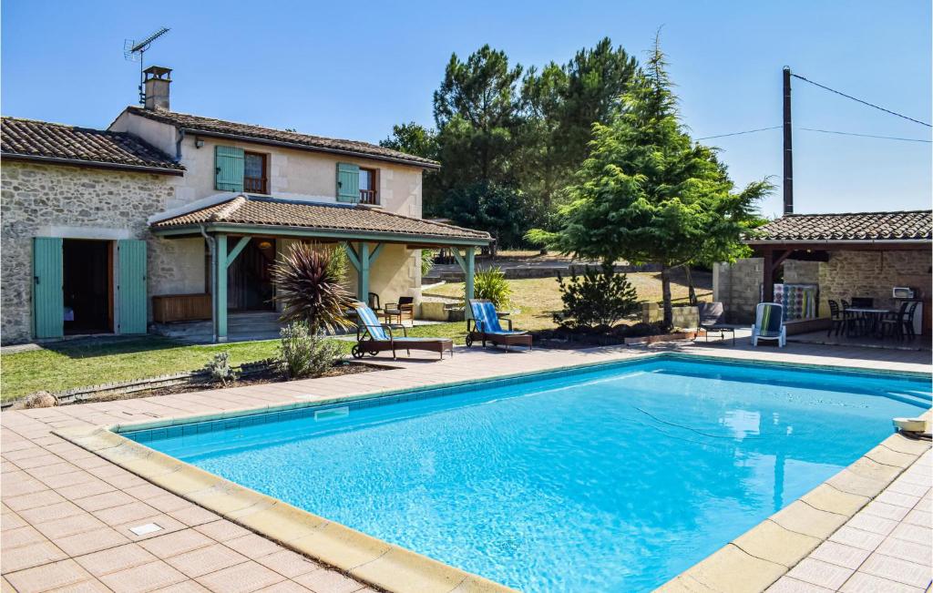 a swimming pool in front of a house at 3 Bedroom Lovely Home In Sainte Gemme in Sainte-Gemme