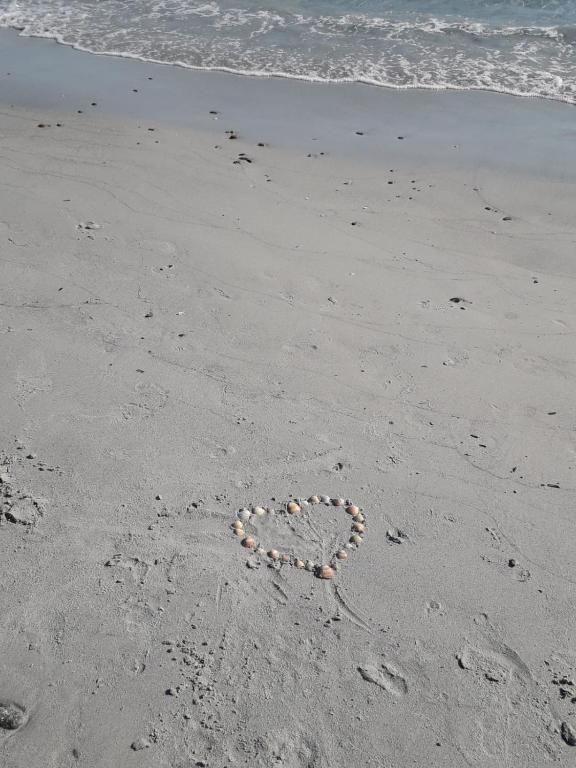 a heart drawn in the sand on the beach at Al Sale in Cagliari