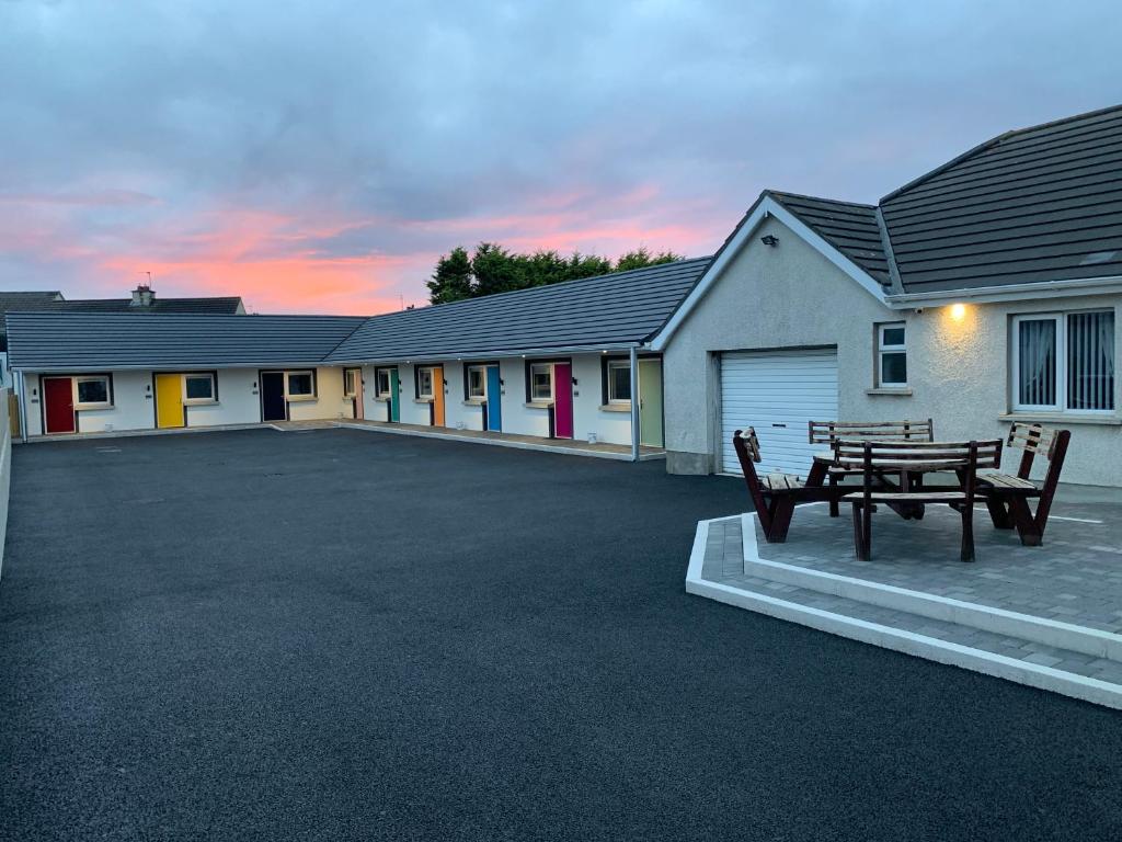 a parking lot with a picnic table in front of a building at North Coast Motel in Portrush